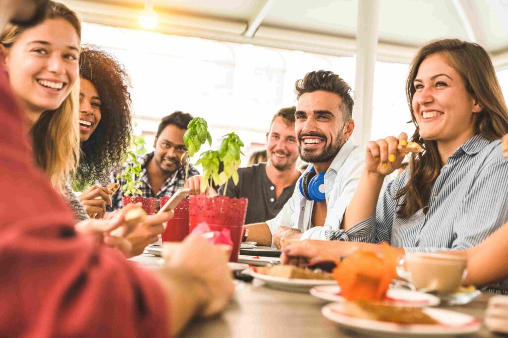 Friends enjoying brunch at a sunny cafe terrace.