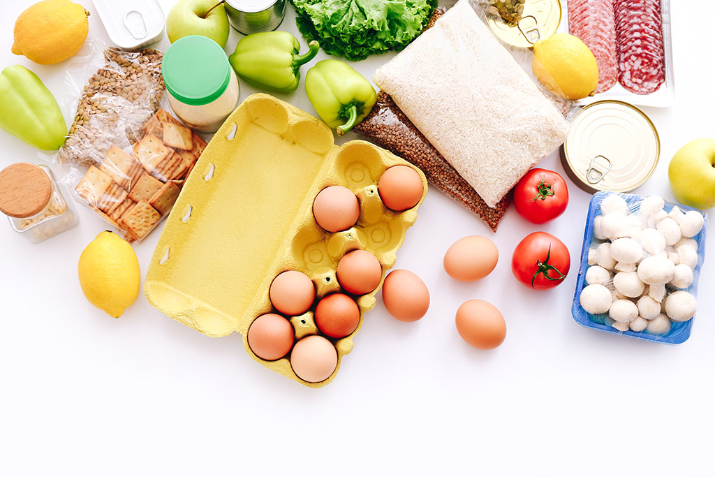 Set of grocery items from canned food, vegetables, cereal on white bacground. Food delivery concept. Donation concept. Top view. PackSafe Compliance Standard